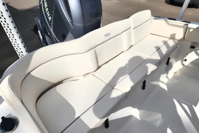 Slide: The Image of 2023 Sea Hunt Ultra 219 boat with white cushioned seating and Yamaha engine. - 14