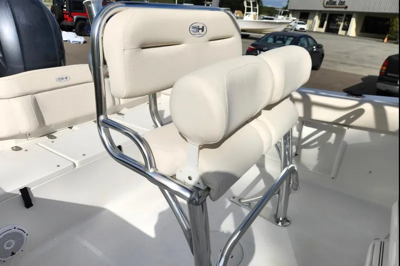 Slide: The Image of 2023 Sea Hunt Ultra 219 boat with white cushioned seating and stainless steel frame. - 15