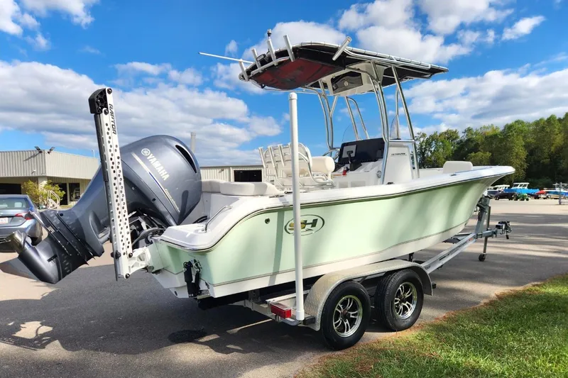Slide: The Image of 2023 Sea Hunt Ultra 219 boat on trailer with Yamaha engine, outdoors. - 4
