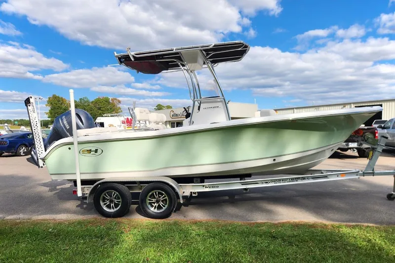 Slide: The Image of 2023 Sea Hunt Ultra 219 boat on trailer under blue sky. - 5