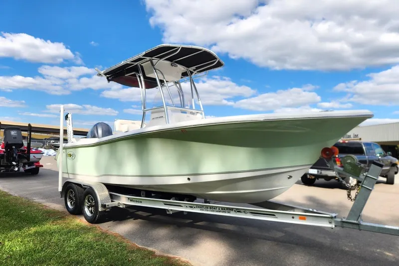 Slide: The Image of 2023 Sea Hunt Ultra 219 boat on trailer under blue sky. - 6