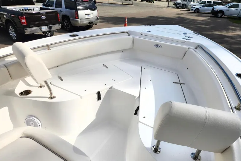 Slide: The Image of 2023 Sea Hunt Ultra 219 boat interior with white seating and storage compartments. - 7