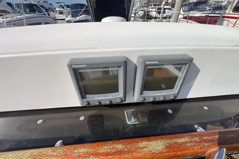 Slide: The Image of Raymarine displays on 2008 Hunter 36 sailboat dashboard in marina setting. - 17