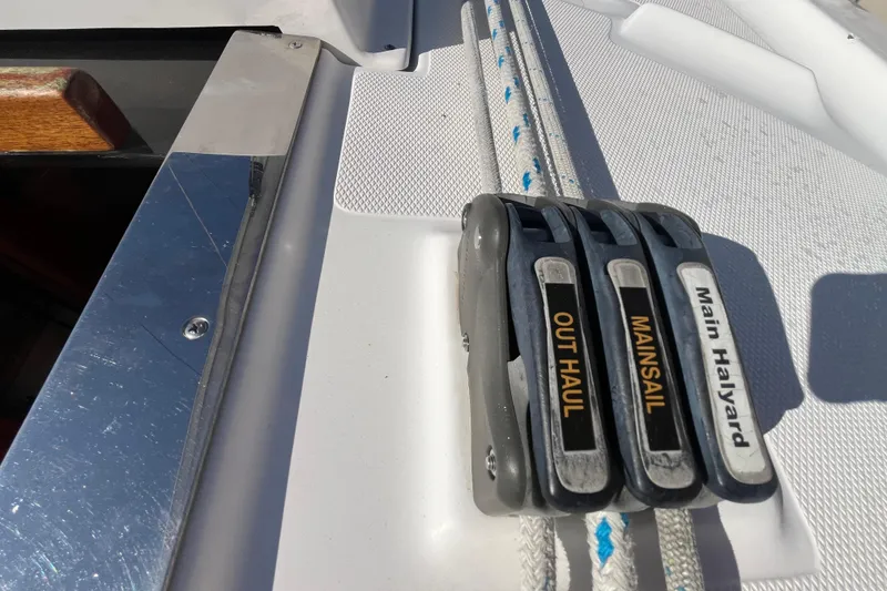 Slide: The Image of Rope clutches on a 2008 Hunter 36 sailboat deck, labeled for mainsail and outhaul. - 20