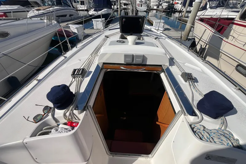 Slide: The Image of 2008 Hunter 36 sailboat deck view with open cabin hatch in marina. - 21