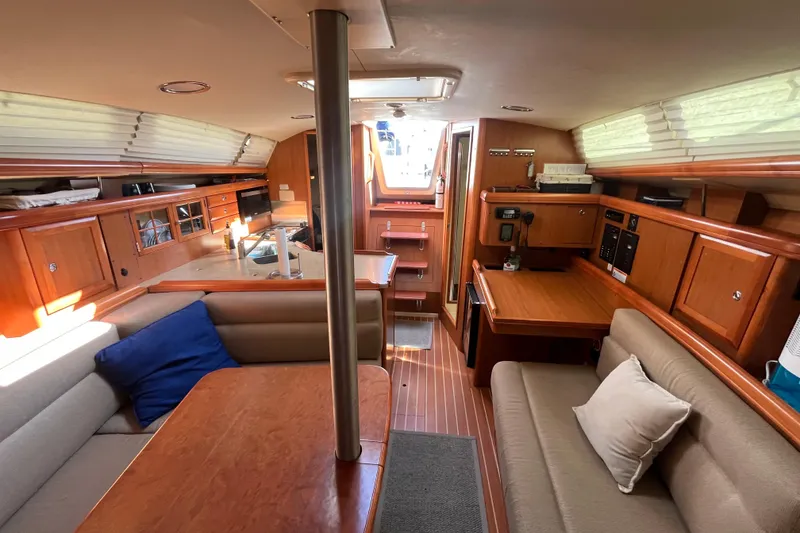 Slide: The Image of Interior of 2008 Hunter 36 sailboat with wood finish and cozy seating area. - 22