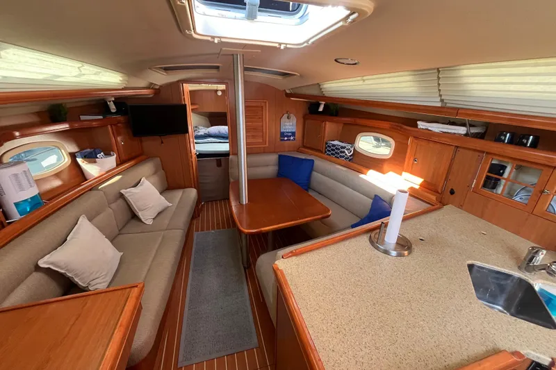 Slide: The Image of Interior of 2008 Hunter 36 sailboat with cozy seating and wooden finishes. - 23