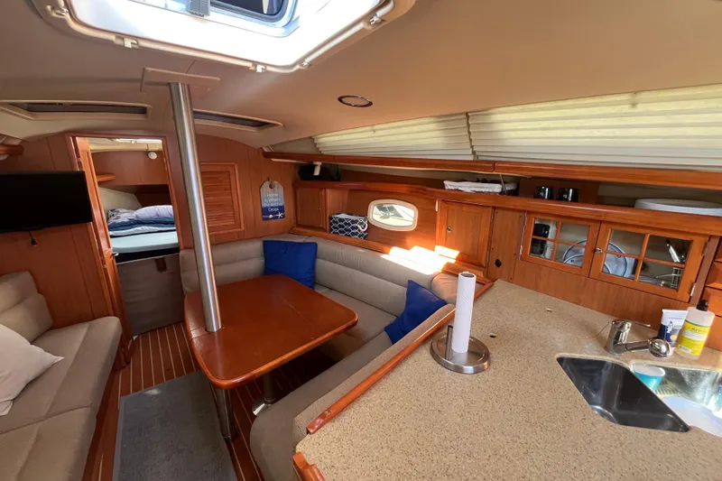 Slide: The Image of Interior of 2008 Hunter 36 sailboat with cozy seating and wooden cabinetry. - 24