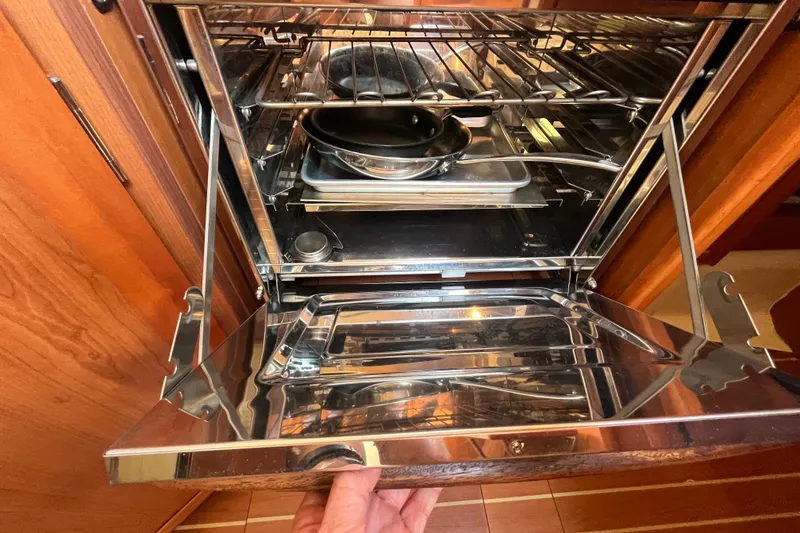 Slide: The Image of Open oven in a 2008 Hunter 36 yacht kitchen with cookware inside. - 27