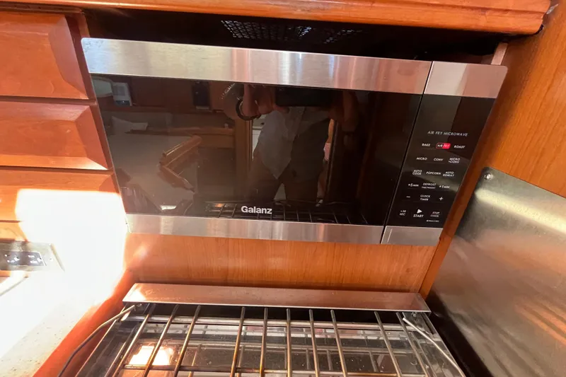 Slide: The Image of Galanz microwave in 2008 Hunter 36 yacht kitchen, with wooden cabinetry. - 29