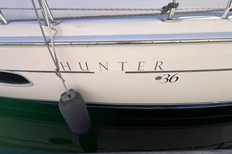 Slide: The Image of 2008 Hunter 36 sailboat side view with fender and railing. - 3