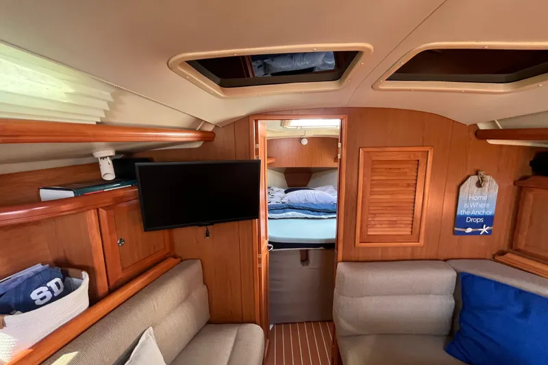 Slide: The Image of Interior of 2008 Hunter 36 sailboat with cozy seating and bedroom view. - 34