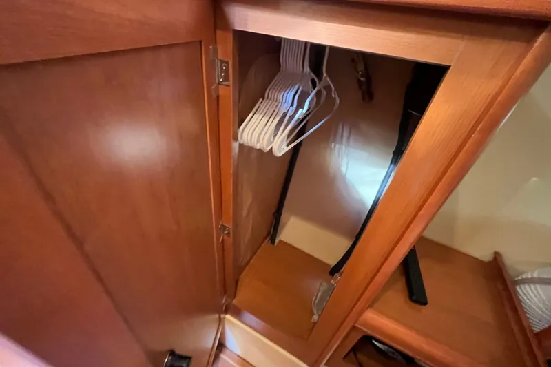 Slide: The Image of Wooden closet interior with hangers in a 2008 Hunter 36 boat. - 40