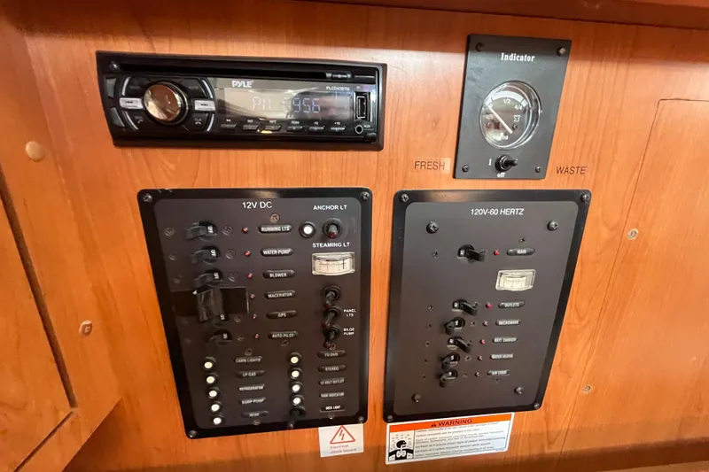 Slide: The Image of Control panel of a 2008 Hunter 36 sailboat with gauges and switches. - 43