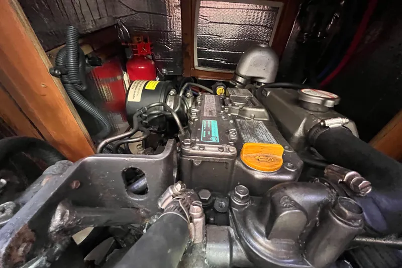 Slide: The Image of Engine compartment of a 2008 Hunter 36 sailboat, featuring mechanical components and wiring. - 49