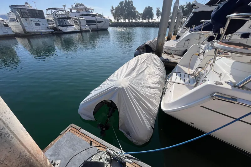 Slide: The Image of Covered boat docked at marina, surrounded by other vessels, Hunter 36 model, 2008. - 5
