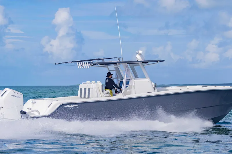 Slide: The Image of 2023 Invincible 35 Catamaran cruising on open water under a clear blue sky. - 14