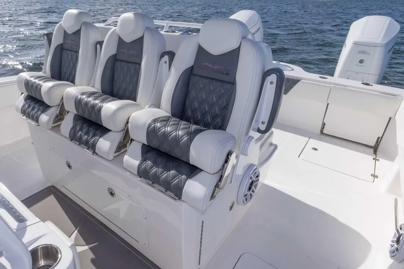 Slide: The Image of 2023 Invincible 35 Catamaran interior with luxurious seating and ocean backdrop. - 27