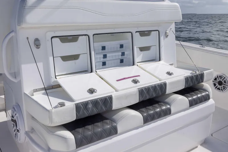 Slide: The Image of 2023 Invincible 35 Catamaran seating with storage compartments on open water. - 34