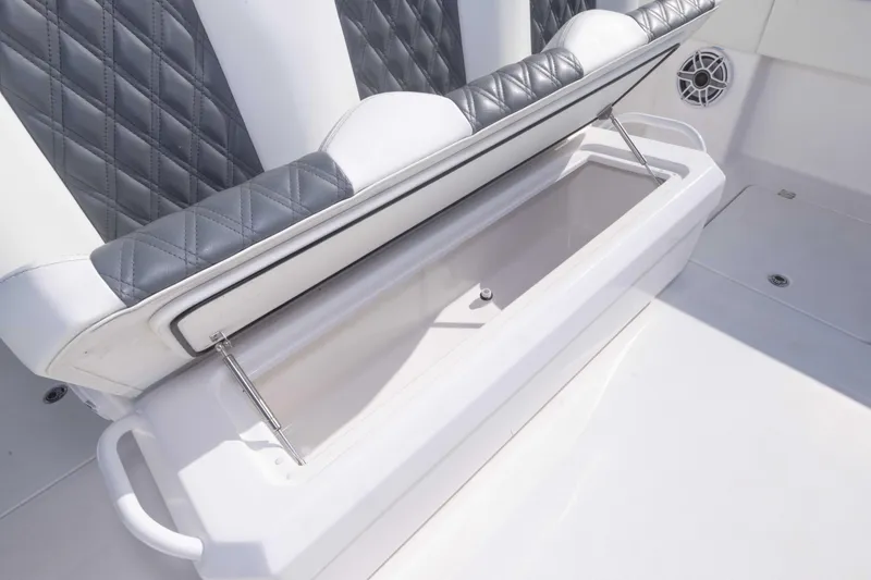 Slide: The Image of 2023 Invincible 35 Catamaran seat storage with diamond-stitched upholstery. - 35