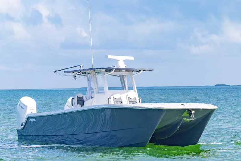 Slide: The Image of 2023 Invincible 35 Catamaran on calm ocean waters under a clear sky. - 6