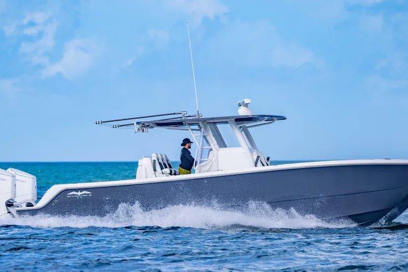 Slide: The Image of 2023 Invincible 35 Catamaran cruising on open water under clear blue skies. - 8