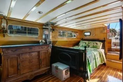 Slide: The Image of 1950 Monk Pilothouse interior with wooden decor and cozy bed. - 12