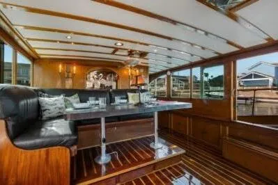 Slide: The Image of Interior of a 1950 Monk Pilothouse boat with elegant wood paneling and seating. - 15
