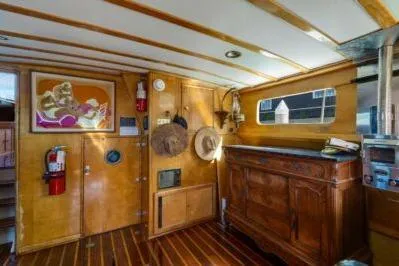 Slide: The Image of Interior of a 1950 Monk Pilothouse boat with wooden paneling and vintage decor. - 6