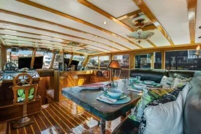 Slide: The Image of 1950 Monk Pilothouse interior with wooden accents, dining area, and helm station. - 7
