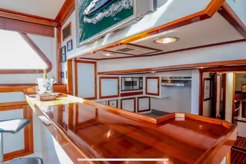 Slide: The Image of Interior of 1969 Islander 72 Aft Cabin Motor Yacht with polished wood and modern amenities. - 11
