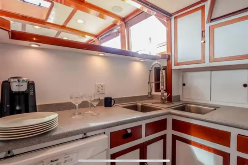 Slide: The Image of 1969 Islander 72 Aft Cabin Motor Yacht kitchen with modern fixtures and elegant cabinetry. - 12
