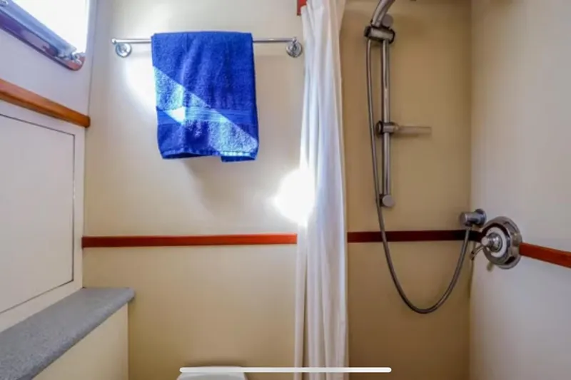 Slide: The Image of Bathroom of 1969 Islander 72 Aft Cabin Motor Yacht with shower and blue towel. - 18
