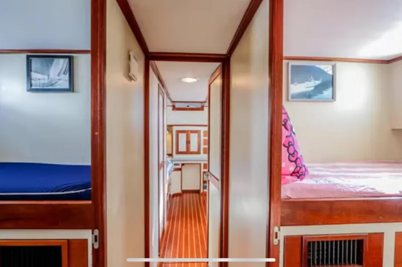 Slide: The Image of Interior of 1969 Islander 72 Aft Cabin Motor Yacht with cozy cabins and wooden accents. - 21