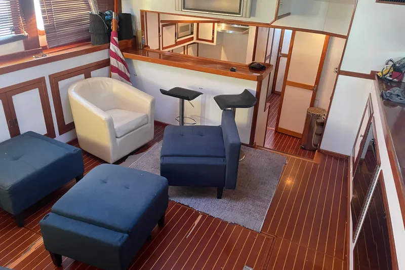 Slide: The Image of Interior of 1969 Islander 72 Aft Cabin Motor Yacht with modern seating and wood accents. - 8
