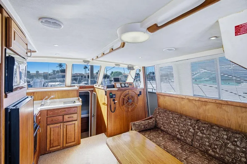 Slide: The Image of Interior of 1998 Mainship 350 Trawler with wood finishes and nautical decor. - 10