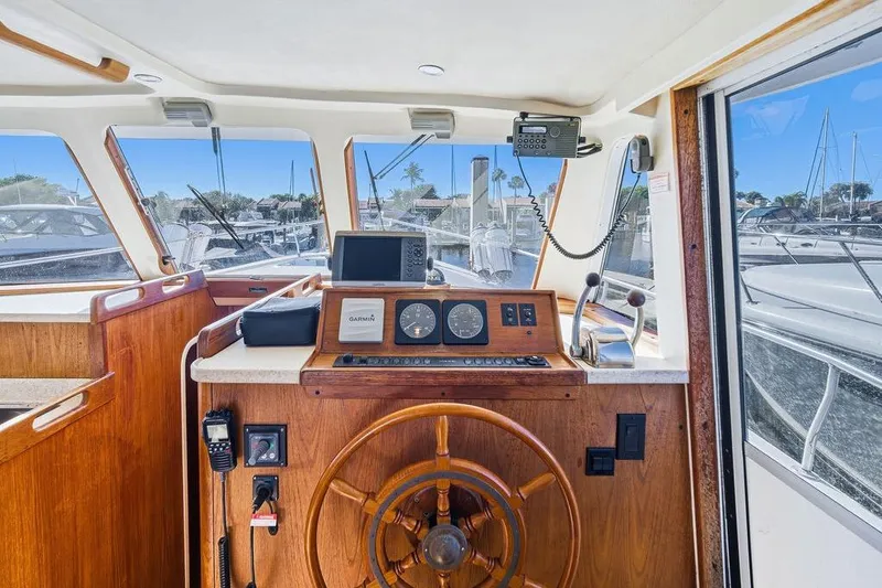 Slide: The Image of 1998 Mainship 350 Trawler helm with wooden wheel and navigation equipment. - 16