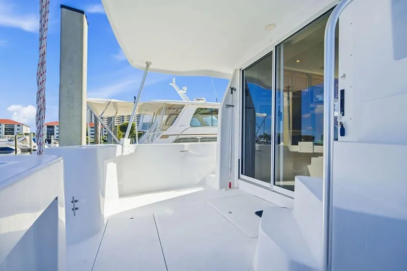 Slide: The Image of 1998 Mainship 350 Trawler deck with sliding glass doors and marina view. - 7