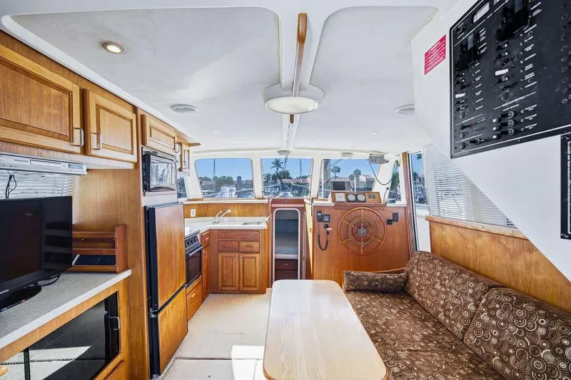 Slide: The Image of Interior of 1998 Mainship 350 Trawler with wood cabinetry and helm station. - 9
