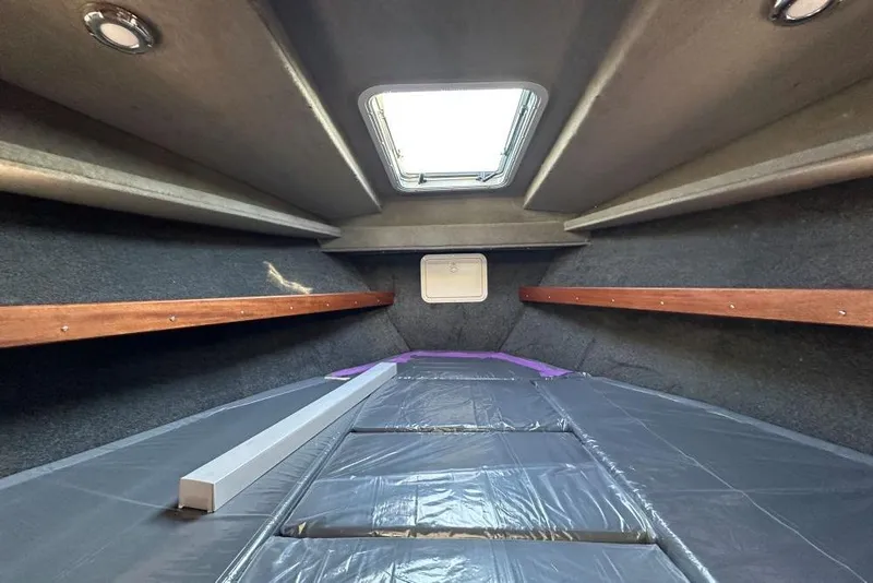 Slide: The Image of Interior cabin of 2026 Hewescraft 270 Pacific Explorer, featuring a skylight and wooden accents. - 10