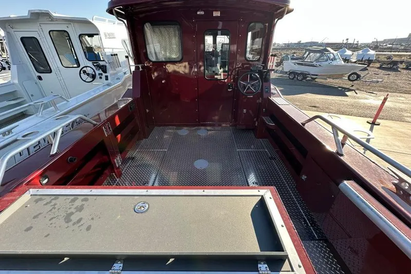 Slide: The Image of 2026 Hewescraft 270 Pacific Explorer boat interior with maroon finish and spacious deck. - 4