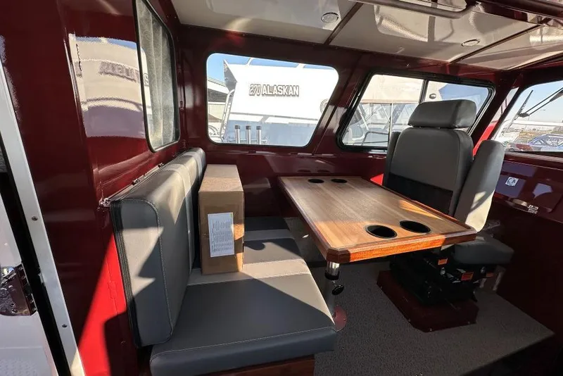 Slide: The Image of Interior of 2026 Hewescraft 270 Pacific Explorer with seating and wooden table. - 7