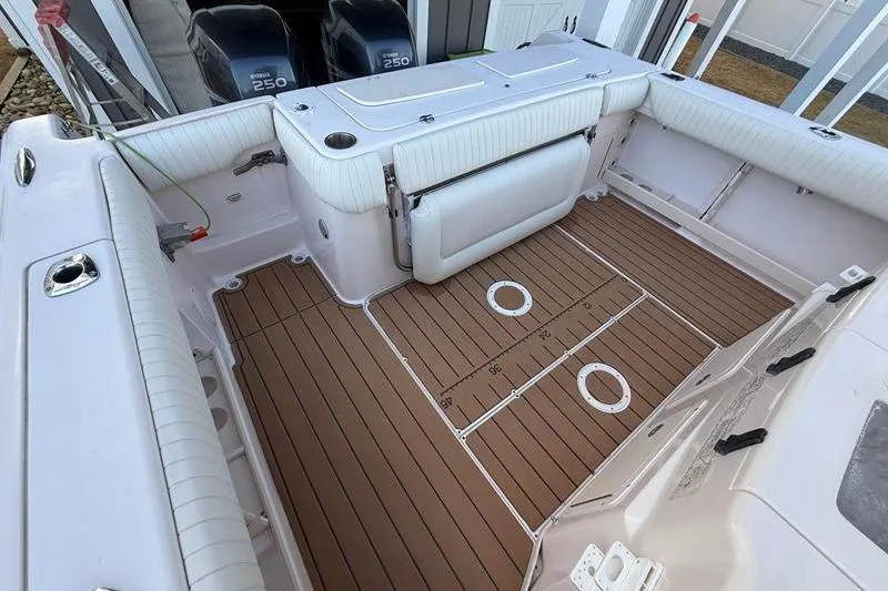 Slide: The Image of 2007 Grady-White Bimini 306 boat interior with teak flooring and twin Yamaha 250 engines. - 11