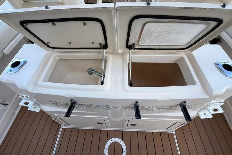 Slide: The Image of 2007 Grady-White Bimini 306 boat with open storage compartments and faucet on deck. - 16