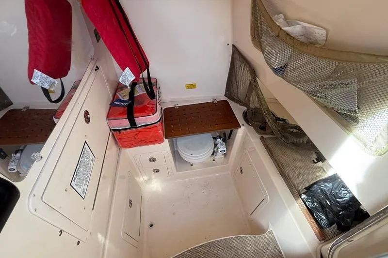 Slide: The Image of 2007 Grady-White Bimini 306 boat interior with storage and marine toilet. - 27