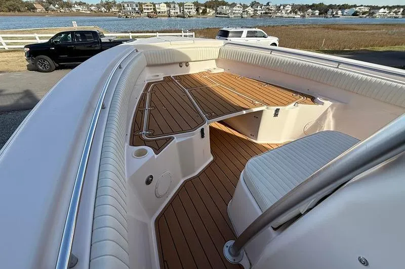 Slide: The Image of 2007 Grady-White Bimini 306 boat with spacious deck and seating, near waterfront homes. - 29