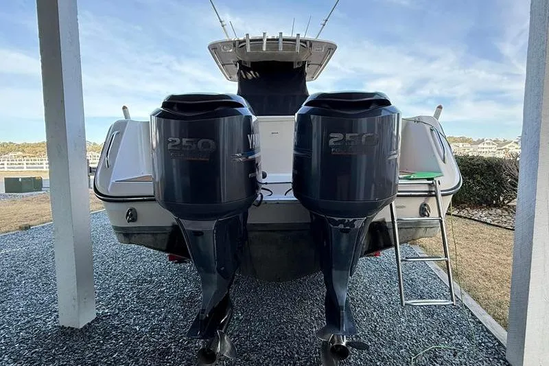Slide: The Image of 2007 Grady-White Bimini 306 boat with twin Yamaha 250 engines, parked outdoors. - 3