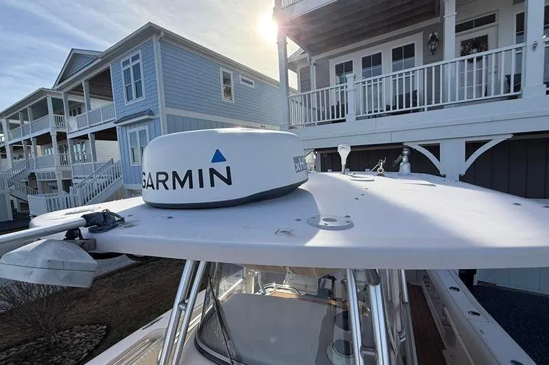 Slide: The Image of 2007 Grady-White Bimini 306 boat with Garmin radar, docked near coastal homes. - 31