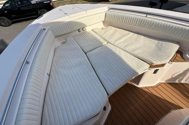 Slide: The Image of 2007 Grady-White Bimini 306 boat interior with cushioned seating and teak flooring. - 32