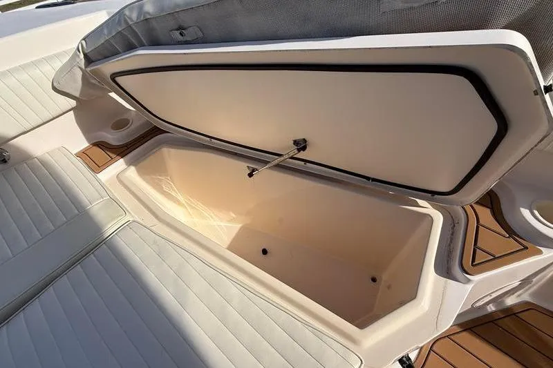 Slide: The Image of Open storage compartment on 2007 Grady-White Bimini 306 boat, featuring cushioned seating. - 35